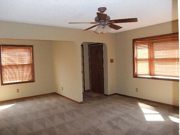 Spacious formal living room w/bow window and dual ceiling fans.