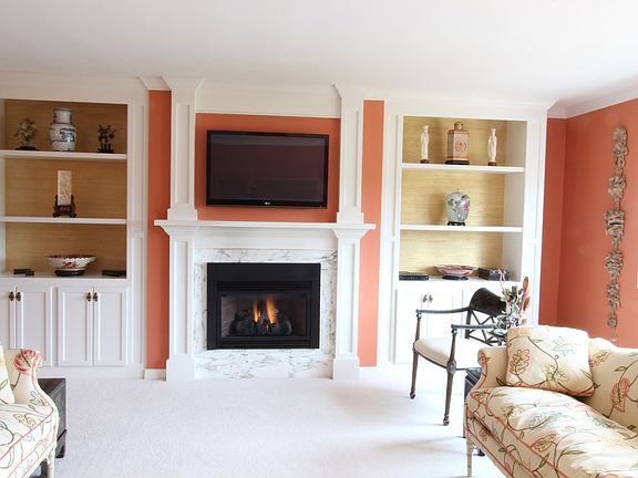 The living room features a gas fireplace and these nice custom shelving units.  all rooms also featu