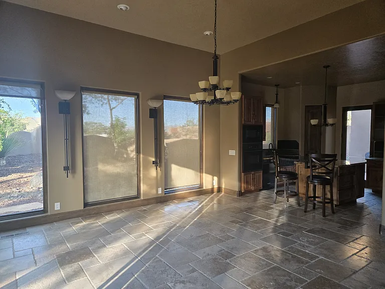 dining area looking out the side windows and kitchen