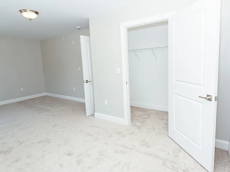 Walk in closet located in this spacious bedroom.