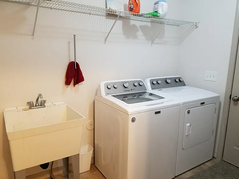 Laundry room with new washer and dryer.