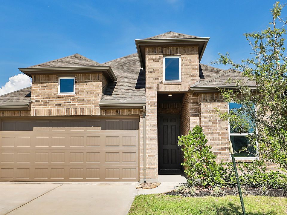 Elegant white-brick facade with upscale grey roofing and expansive double garage. Located in Ellis C