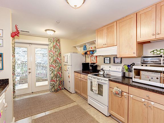 Kitchen is almost 200 ft2 and includes full size range, refrigerator, dishwasher, and microwave.