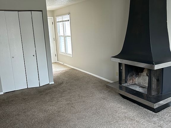 LIVINGROOM REFLECTING FIREPLACE, ENTRANCE DOOR WAY AND COAT CLOSET
