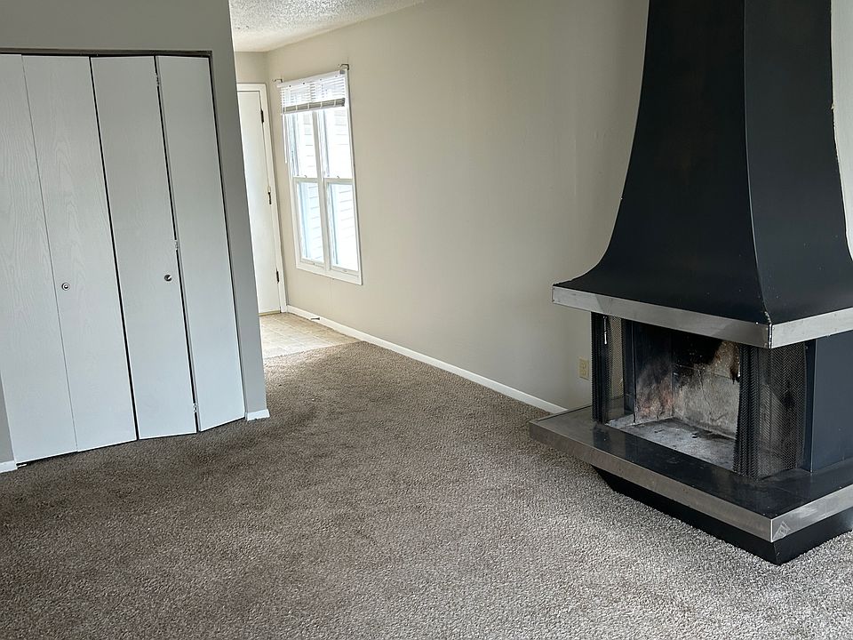 LIVINGROOM REFLECTING FIREPLACE, ENTRANCE DOOR WAY AND COAT CLOSET