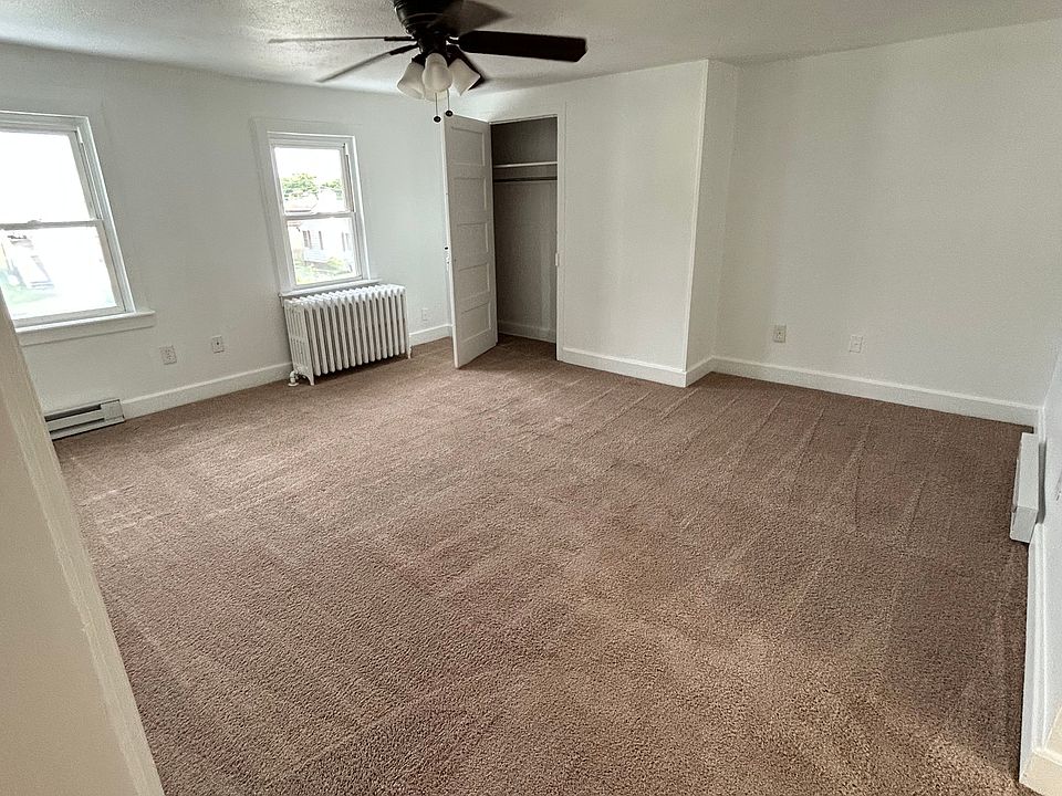 Roomy living room area include an abundance of natural light, ceiling fan, and spacious closet.