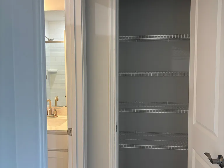 Extra storage outside of master bathroom for towels and toiletries.