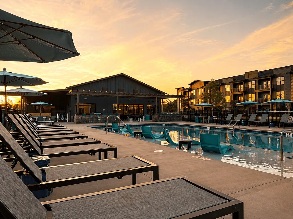 Resort-style pool featuring a baja shelf and expansive sundeck for lounging.