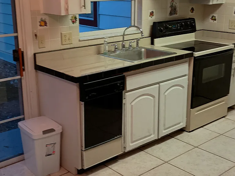 Left side of kitchen, right side has refrigerator.