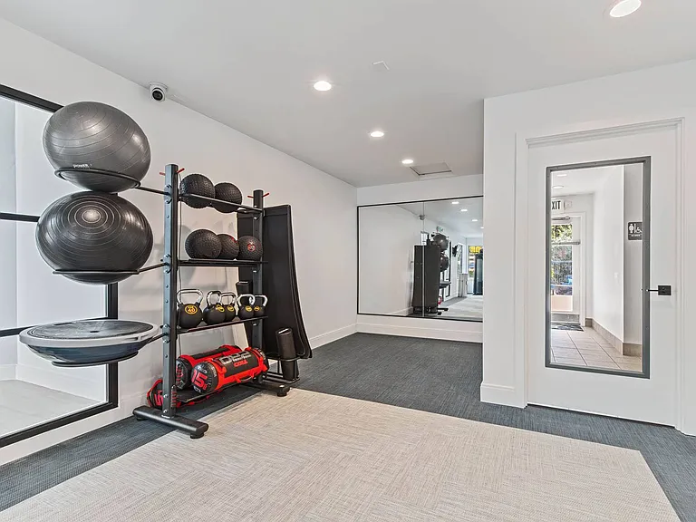 A bright, modern fitness space designed for stretching, strength, and cardio