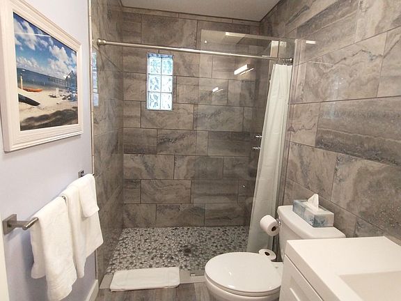 Custom tile primary en suite bathroom with luxury shower sprayers