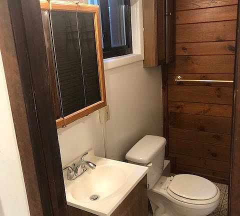 Bathroom which also has a stand up shower in front of the toilet area. Tile flooring