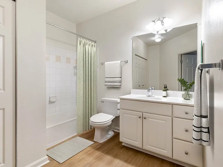 Classic I bath with white cabinetry, white laminate countertops, and hard surface flooring