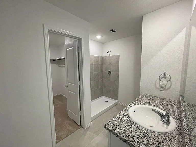 Primary bath with large walk in shower. Shower has been enclosed.
