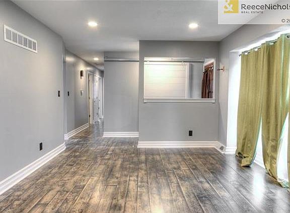 Entryway features stylish barndoor closet door
