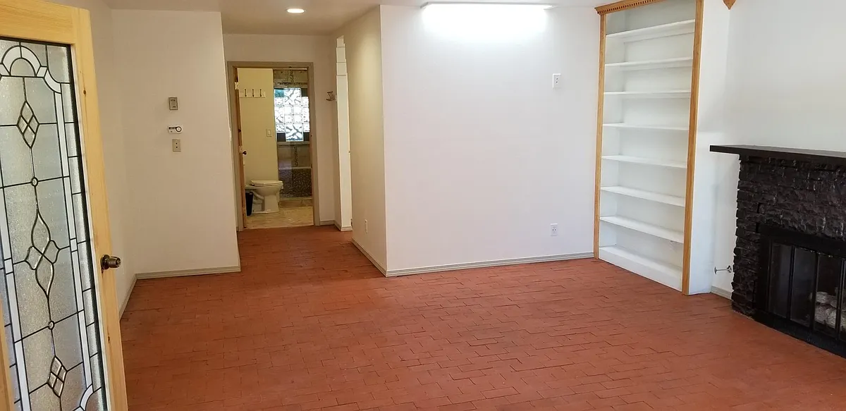600 SF (shown here unfurnished) Master Suite (west end) with private bath, walk-in closet, built in book shelves and fireplace - Tiley Dr NE
