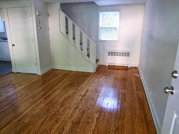 Entrance through the front door. Kitchen to the left. Stairs to the 2nd floor straight ahead.
