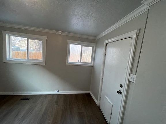 Bedroom 1 showing pet door with backyard patio access