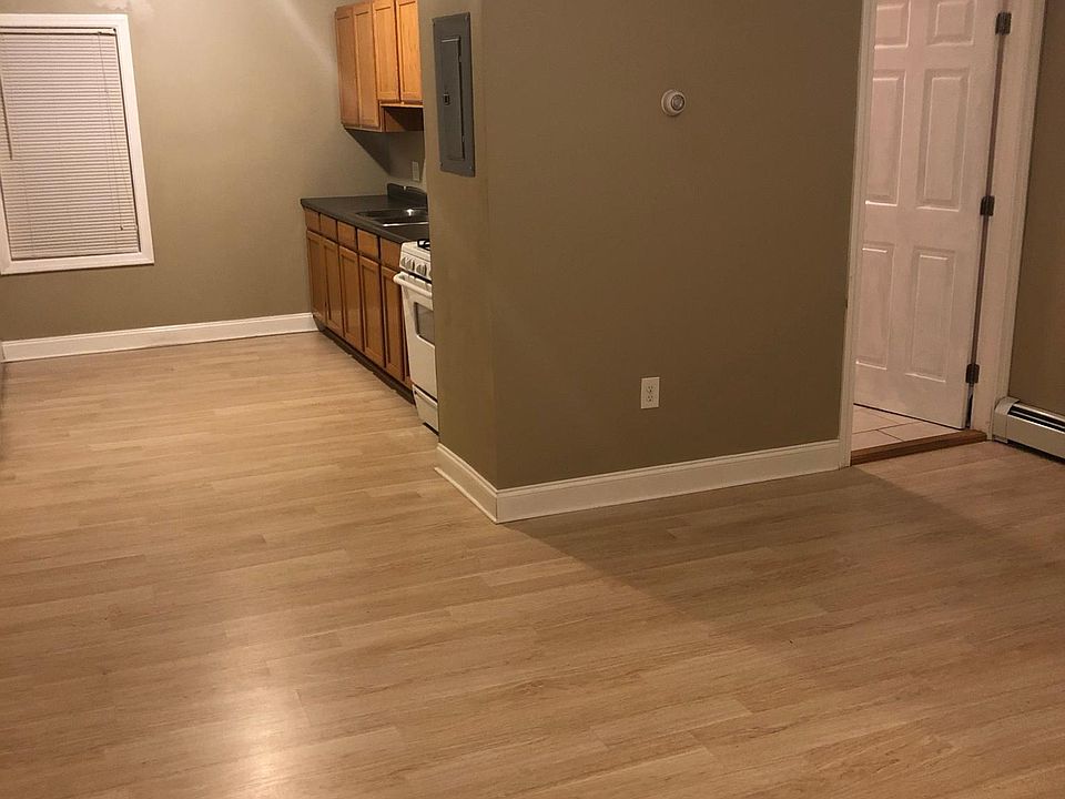 Living Room looking into kitchen. Door on right leads to bathroom.