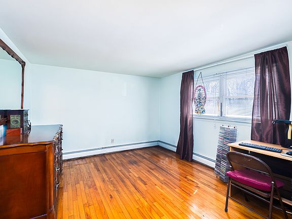 Bedroom with windows looking out over front yard