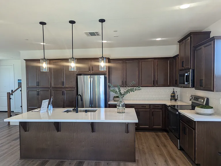 Kitchen.
This is a model home. Actual home will have dark granite.