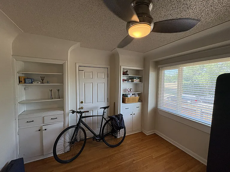 Main floor bedroom with access to private backyard porch from door