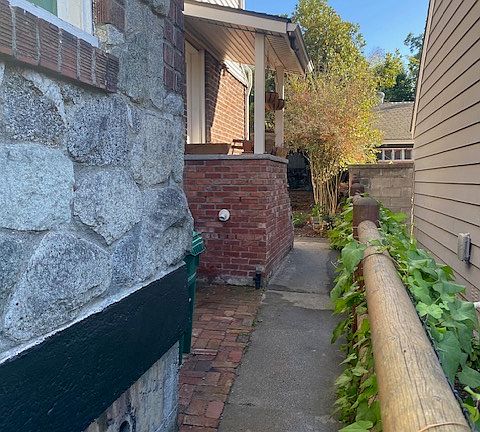 Looking South, walkway to basement entrance on Left.