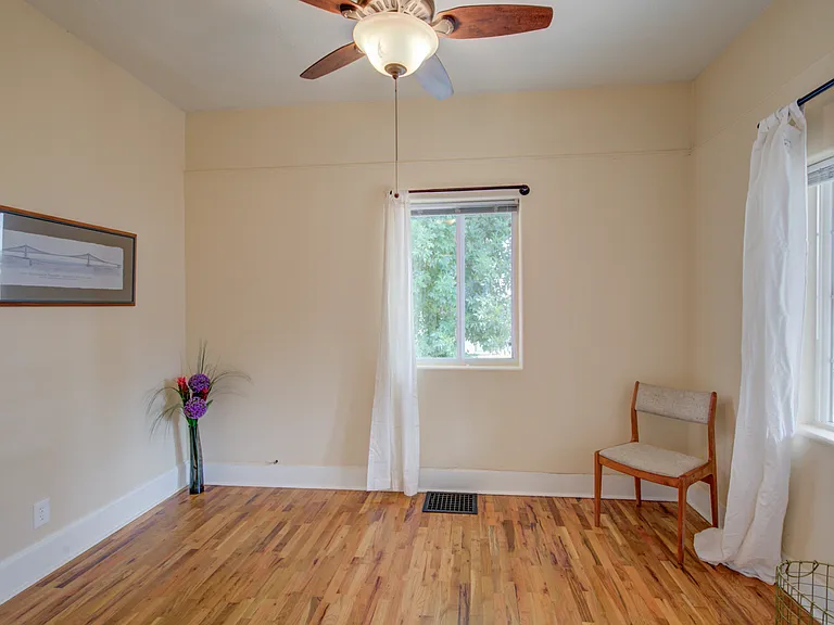Bedroom # 1 looks out to front porch
hardwood floor and ceiling fan
