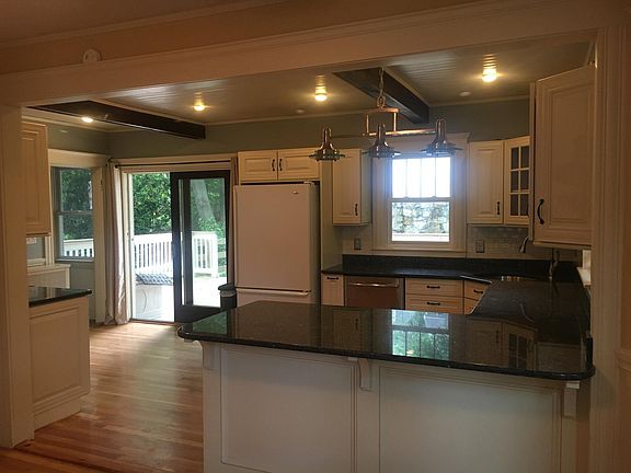 Kitchen slider doors to large back/ private deck Fridge has been updated to stainless