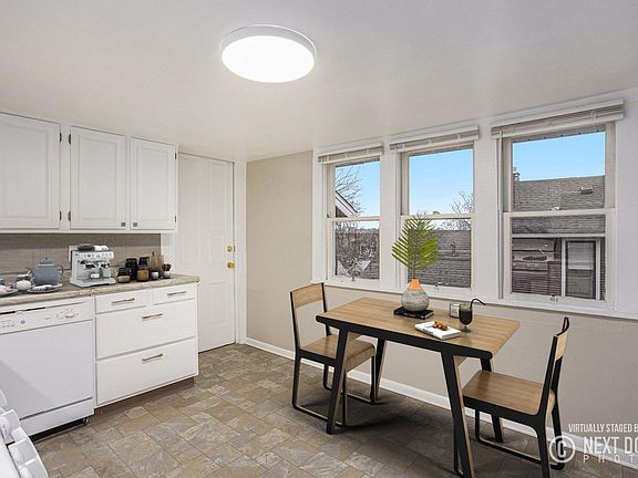 Kitchen with dining area that has been virtually staged.
