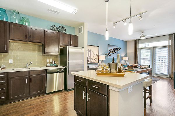 Luxurious kitchen, stainless steel appliances, stunning large islands and faux wood flooring.