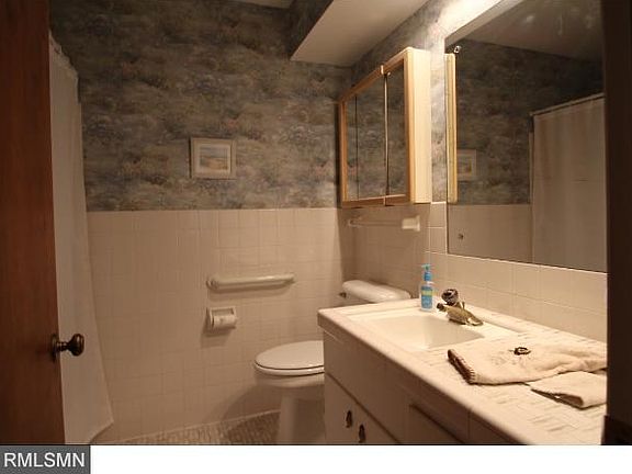 Main floor full bath is sparkling and has great storage space for toiletries.