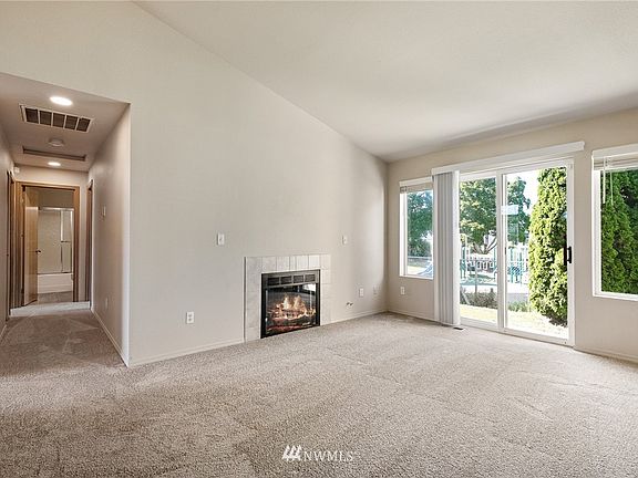 The comfortable and cozy and living room features new plush carpeting. 