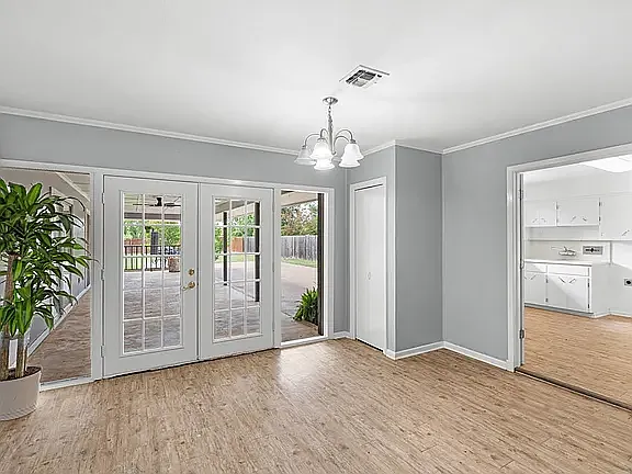 View of Dining Room, Pantry/closet, Patio, Utility/Hobby/Sewing Room with large 2 bowl sink, washer/dryer connections, built in ironing board, and counters and cabinets for storage for sewing/hobbies