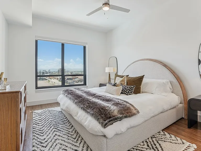 Wake up to sweeping views and soft morning light in this cozy-chic bedroom.