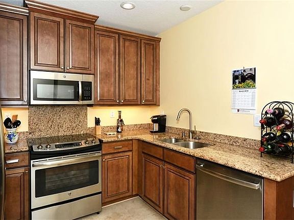Kitchen offers 42" wood cabinets, granite and stainless appliances.