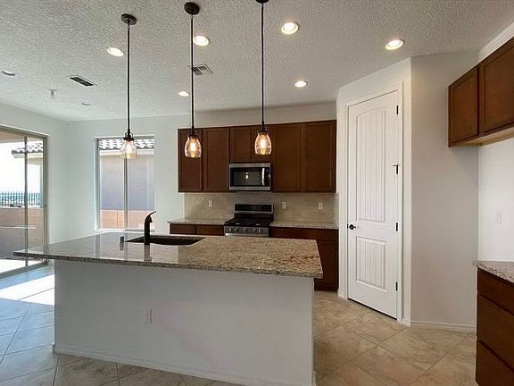 Kitchen with granite countertops and pendant lighting
