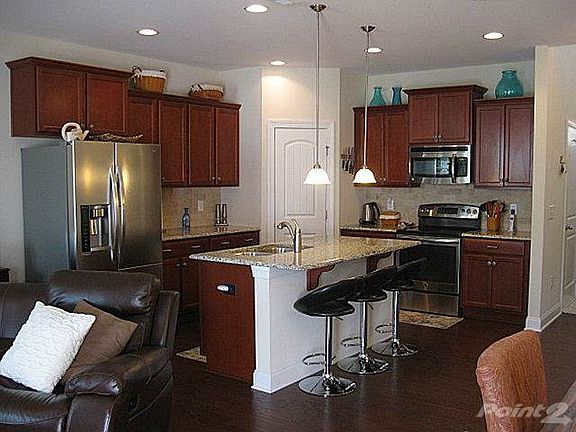 The cook or baker of the family will love this kitchen with its granite countertops, tile backsplash, stainless steel appliances (refrigerator stays!), pantry closet and island with breakfast bar!