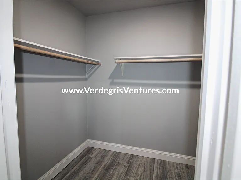 A well_sized walk_in closet adds convenience and storage to the principal bedroom