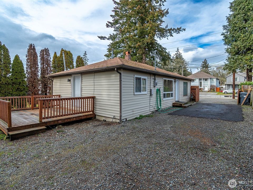Long driveway into back of property. Wood deck attached to the back of the home. Fenced on three sides of the property.>