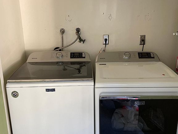 Washer and dryer located in private balcony.