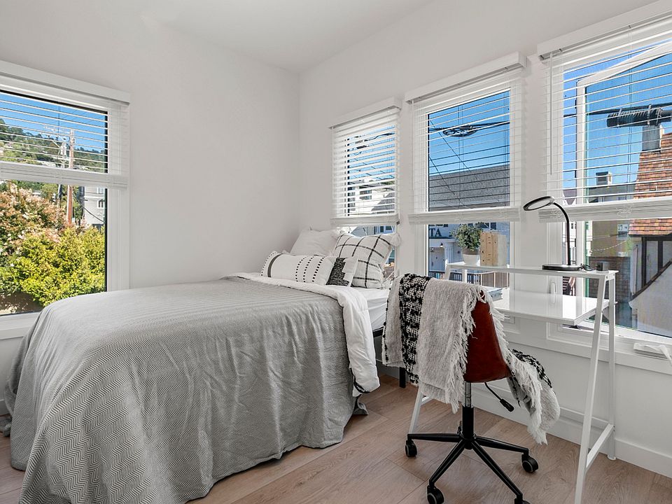 Bright bedroom with modern decor and large windows