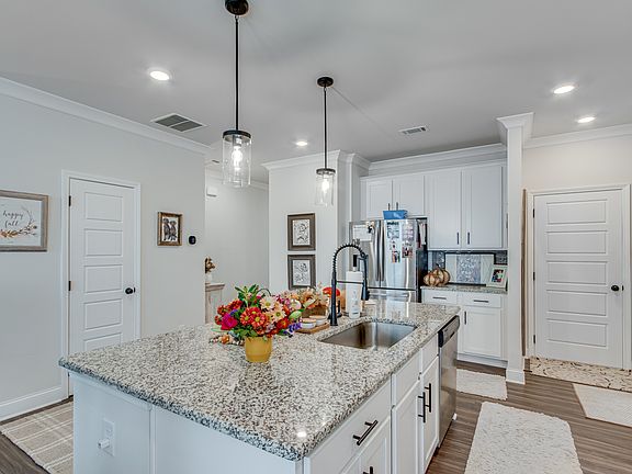 large kitchen area with an island for hosting or feeding your family at.