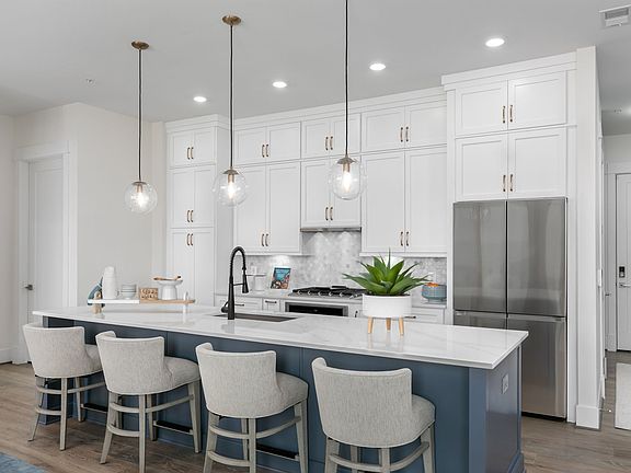 Elevated finishes and modern appliances adorn an impressive kitchen.