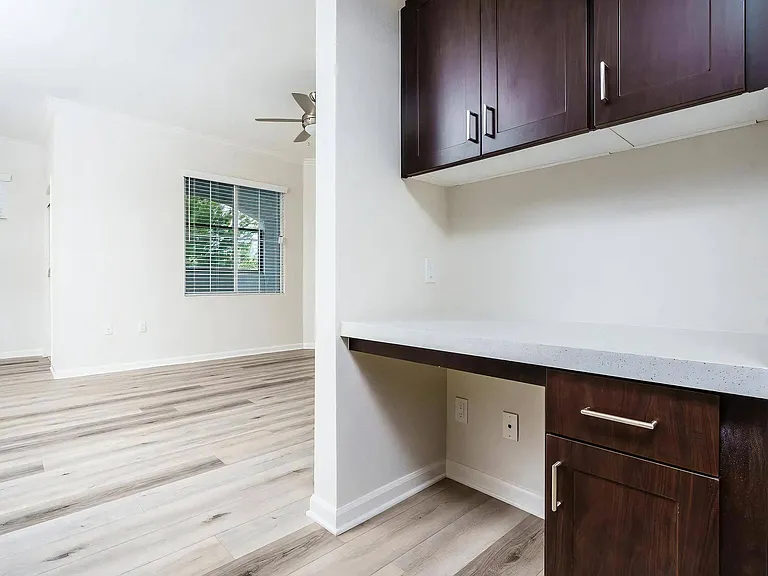 Built-In Apartment Workspace with Overhead Storage Cabinets