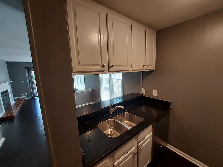 White Cabinets, Granite Counters, Disposal, and stainless appliances throughout the kitchen.