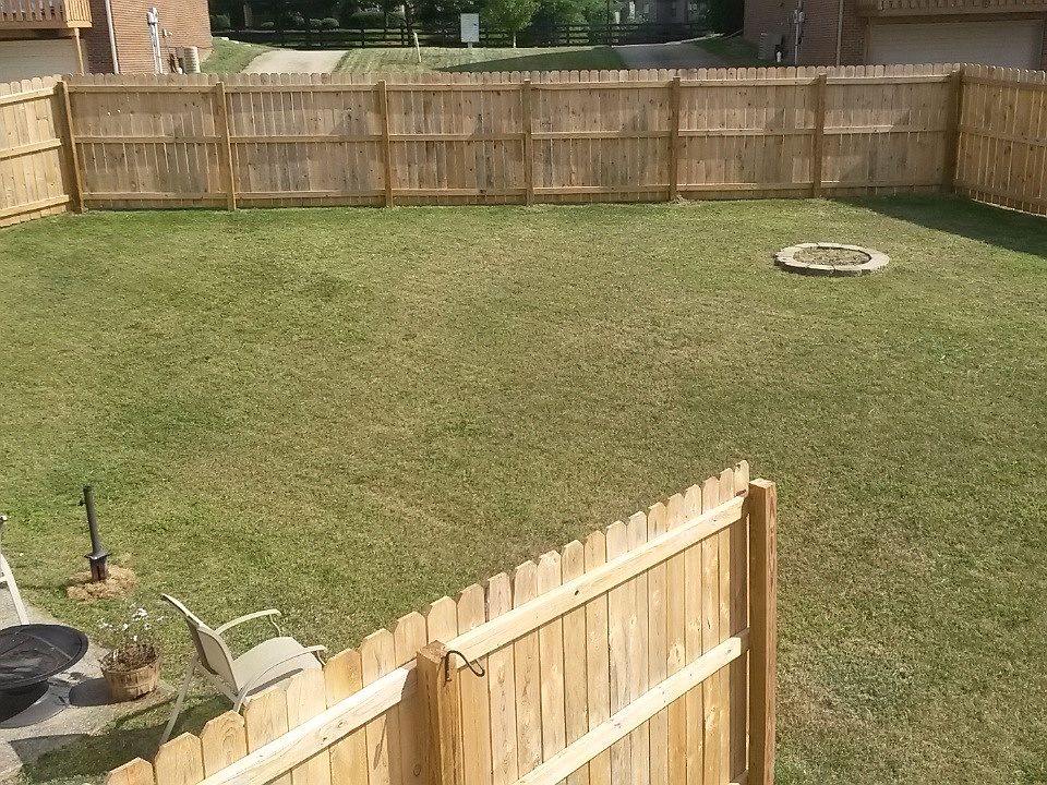 Large, fully fenced in backyard with privacy fence between u