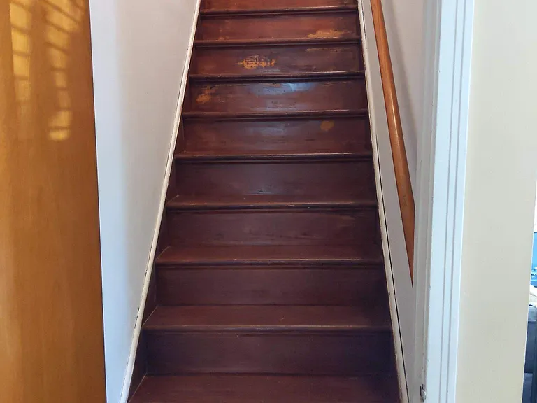 Enclosed staircase leads to the upper level.