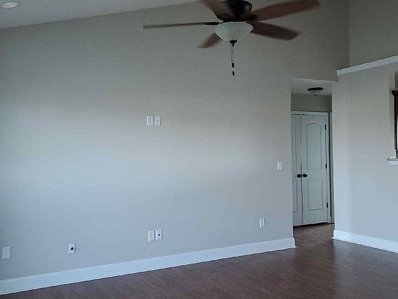 Vaulted living room with open floorplan to kitchen & dining area