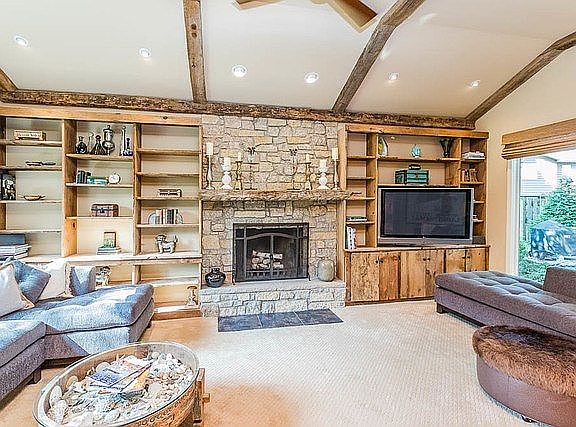 Sunken living room  Modern Rustic touched abound.  Wisconsin Barn Hood custom built ins surround wood burning fireplace.